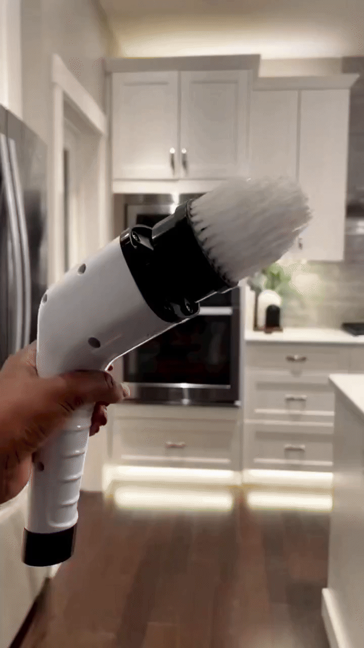 User cleaning kitchen counters with electric spin scrubber