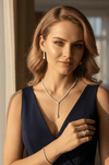 Elegant Blonde Model Wearing the Complete Gold Plated Teardrop Jewelry Set while Posing in a Luxury Dark Blue Evening Gown