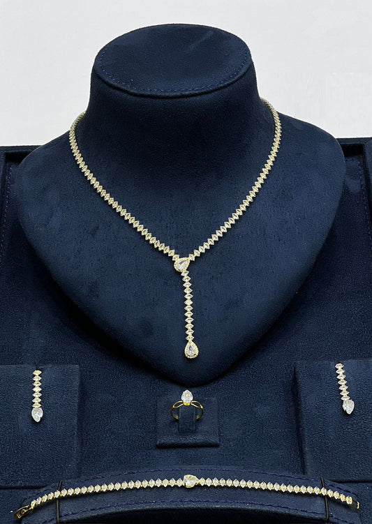 Zalviro Elegant Teardrop Jewelry Set Featuring Sparkling Gold Plated Cubic Zirconia Pendant Necklace Matching Drop Earrings Solitaire Ring and Bracelet on Velvet Stand