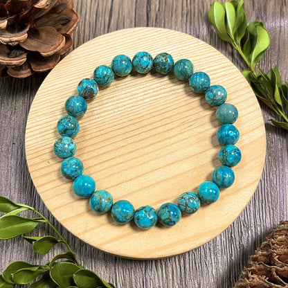 Zalviro Premium South African Turquoise Stone Bracelet Featuring Round Blue Green Marbled Beads Arranged On A Round Wooden Display Block