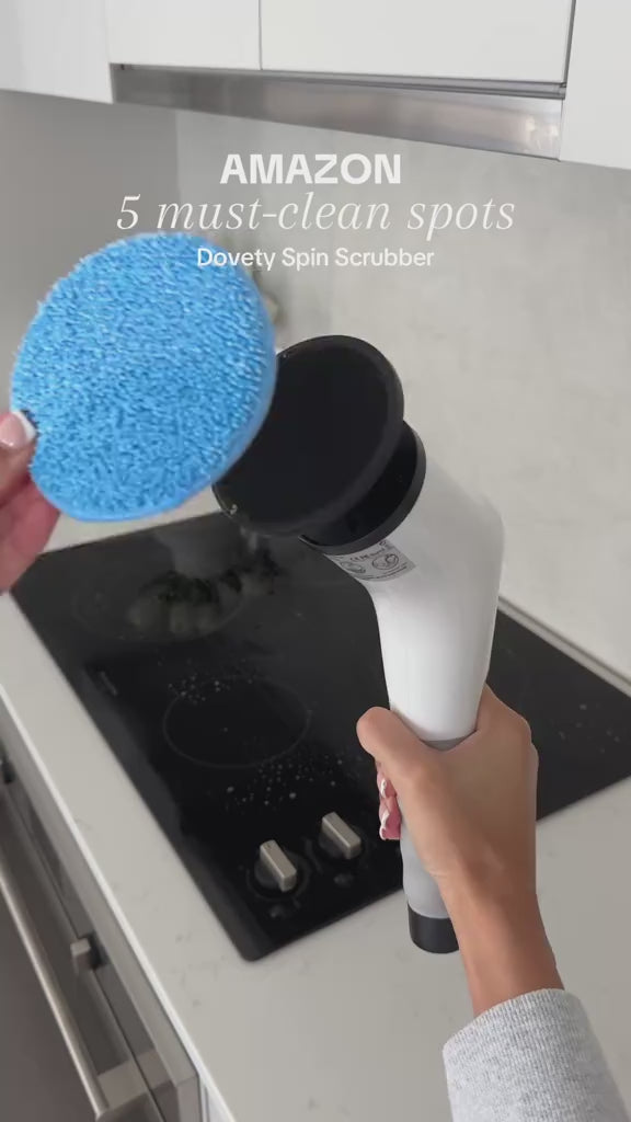Handheld cordless electric spin scrubber cleaning a stovetop