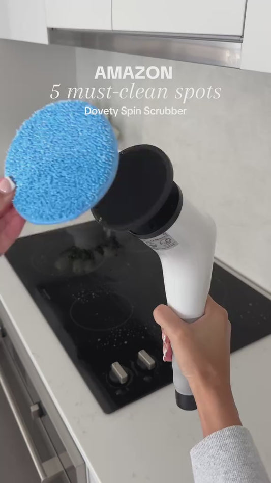 Handheld cordless electric spin scrubber cleaning a stovetop
