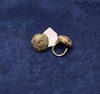 Flat Lay Studio Product Photography Showcasing Top Geometric Texture and Tapered Band Details of Statement Ring against Blue Fabric